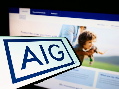 Stuttgart, Germany - 09-08-2022: Smartphone with logo of company American International Group Inc. (AIG) on screen in front of business website. Focus on center of phone display.