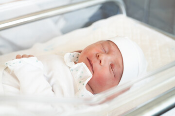 newborn. baby newborn a close-up lies with eyes closed in the hospital maternity hospital. lifestyle happy family baby dream concept. cute newborn baby wrapped in a blanket
