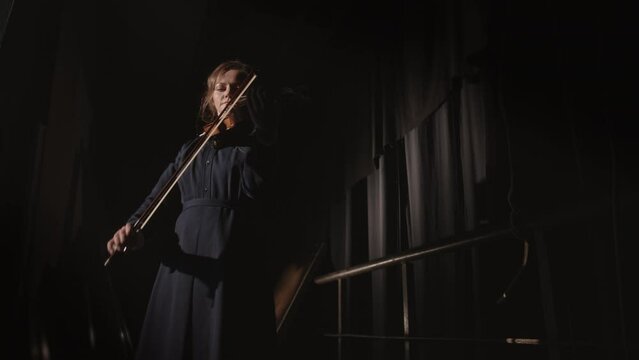 Female violinist performing on stage