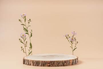 Wooden slice podium with flowers on beige background. Concept scene stage showcase, product,...