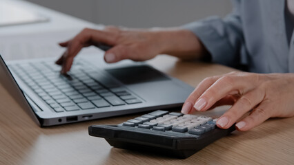 Close up female hands with manicure wrinkled unrecognizable senior woman cashier accountant calculate financial data pay online bills on computer planning budget managing bank finances costs economy