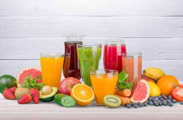 Healthy colored fruits and vegetables smoothies onthe desk