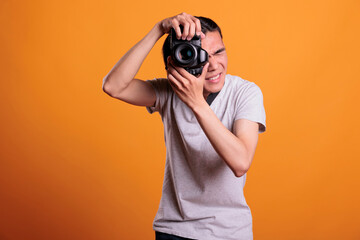 Photographer taking portrait photo on professional dslr camera, young asian man using photographing...