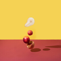 Creative arrangements summer fruit on the dark red and yellow background. Minimal nature concept.