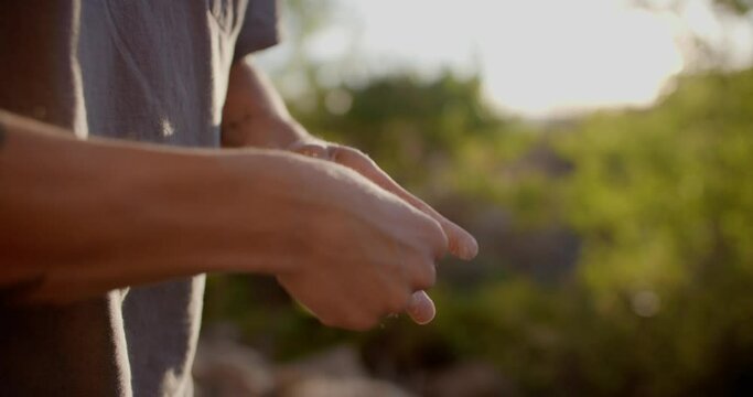 Close Up Of Climber Taping Finger Before Rock Climbing