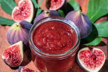 Sweet figs jam and raw figs closeup. Figs whole and cut into halves. Organic gardening