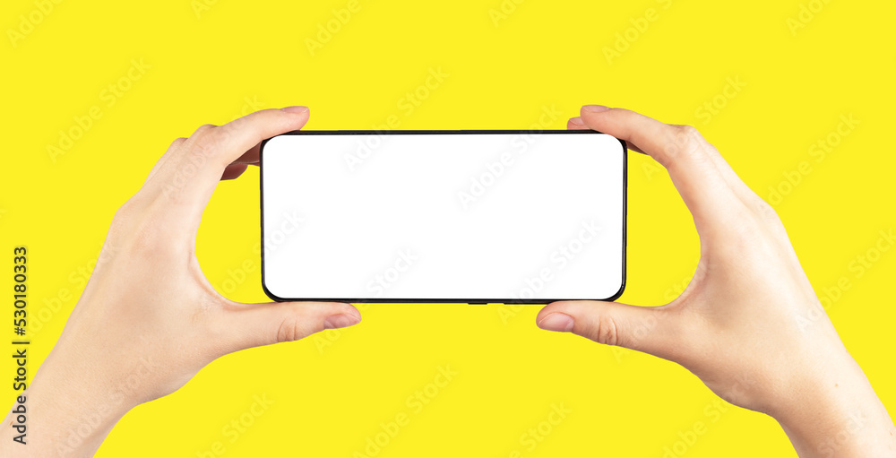 Poster Hands holding phone mockup in horizontal position for watching video on yellow background. Smartphone template with empty display.