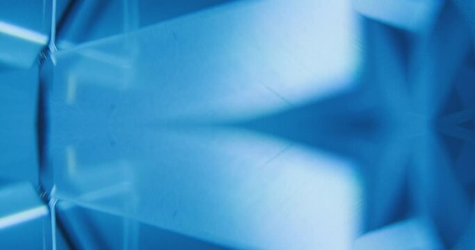 Neon flash light. Futuristic abstract background. Defocused blue white color gradient flicker rays glow free space for text. Seamless loop rotation. Shot on RED Cinema camera.