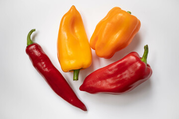 Red and yellow peppers on a white background.
