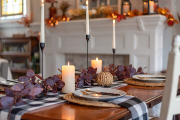 Cozy dining table by a fireplace decorated for fall - 530181751