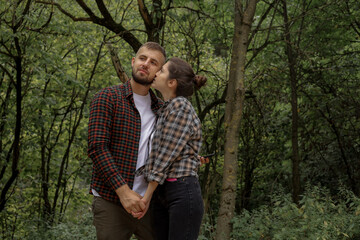 Fototapeta premium a couple in love outdoors in the forest