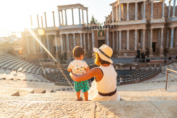 Roman Ruins of Merida, a mother with her baby visiting the Roman Theater. Extremadura, Spain