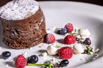 chocolate cake dessert with meringue and raspberries