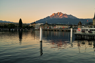 Rippling river in old city under cloudless sunset sky