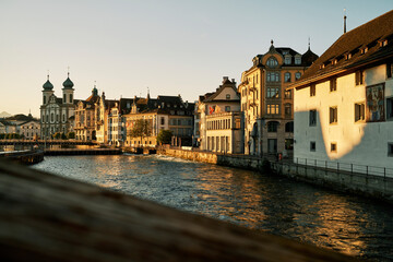 Exteriors of old buildings and Catholic church near river in old town