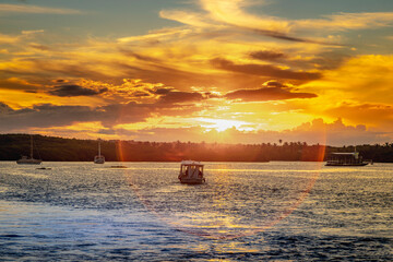 Idyllic Beach at sunset with palm trees and boats in Porto Seguro , BAHIA