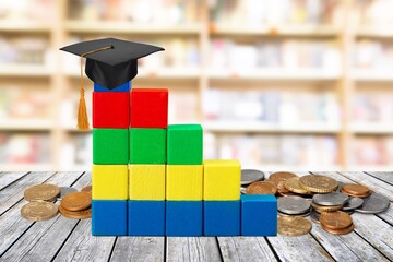 Graduate study concept with a cap on increasing bar graph