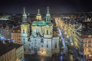 Fototapeta na wymiar Above baroque church of Saint Nicholas in Prague old town square at night