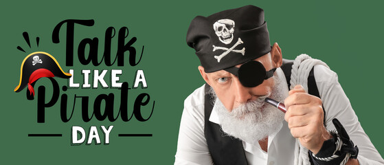 Mature pirate with smoking pipe on green background. Talk Like a Pirate Day