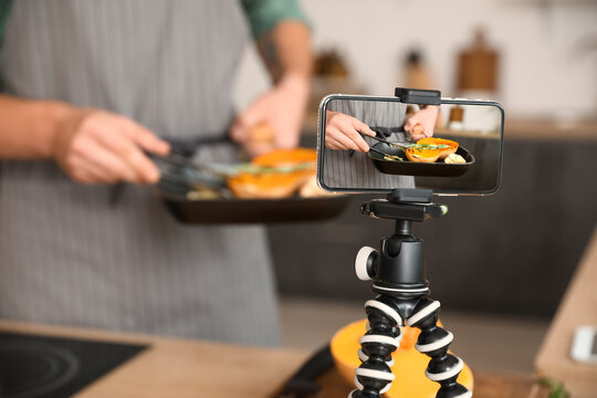 Male chef recording new video recipe in kitchen