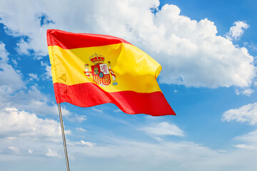 Waving flag of Spain against blue sky