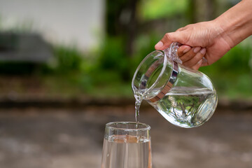 pouring water into glass