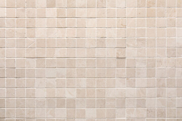 Beige tile wall as background, closeup