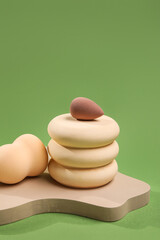 Stand with makeup sponges on green background