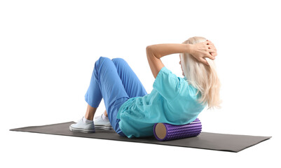 Mature physiotherapist training with foam roller on white background