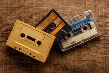 Old cassette tapes on a wooden table.
