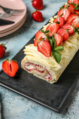 Board with tasty strawberry roll cake on color background, closeup