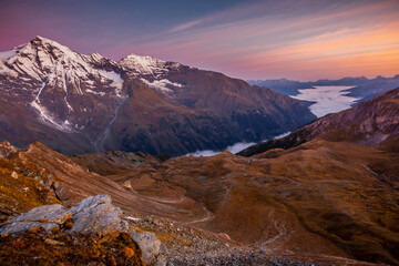 Misty valley from above Grossglockner and mountain landscape at dawn, Austria