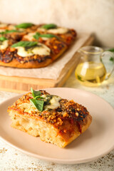 Plate with piece of delicious Italian pie on light background, closeup