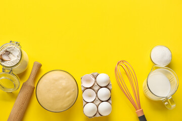 Composition with ingredients for baking and raw dough on yellow background