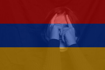 War between Armenia and Azerbaijan. Young woman with sad sight looking at camera. Woman screaming. Armenia flag. Face of depression. Caucasian woman. Crisis. Out of focus