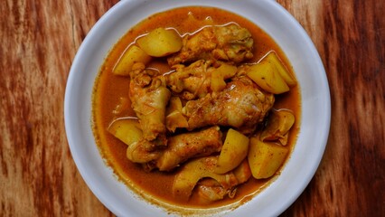 Gulai ayam dan kentang. Indonesian chicken curry with potato. Is traditional side dish from Minangkabau cuisine