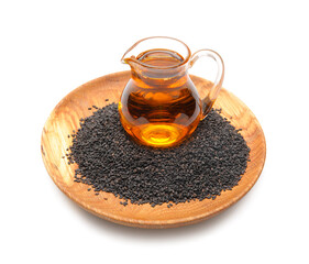 Wooden plate with sesame seeds and jug of oil on white background