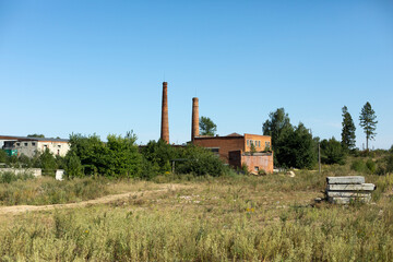Fototapeta na wymiar Pipe plant. Brick factory in countryside. Industrial zone outside city.