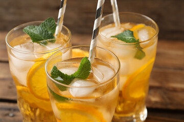 Fototapeta premium Delicious refreshing drink with orange slices on table, closeup