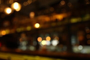 Blurred view of stylish modern bar interior with bokeh effect