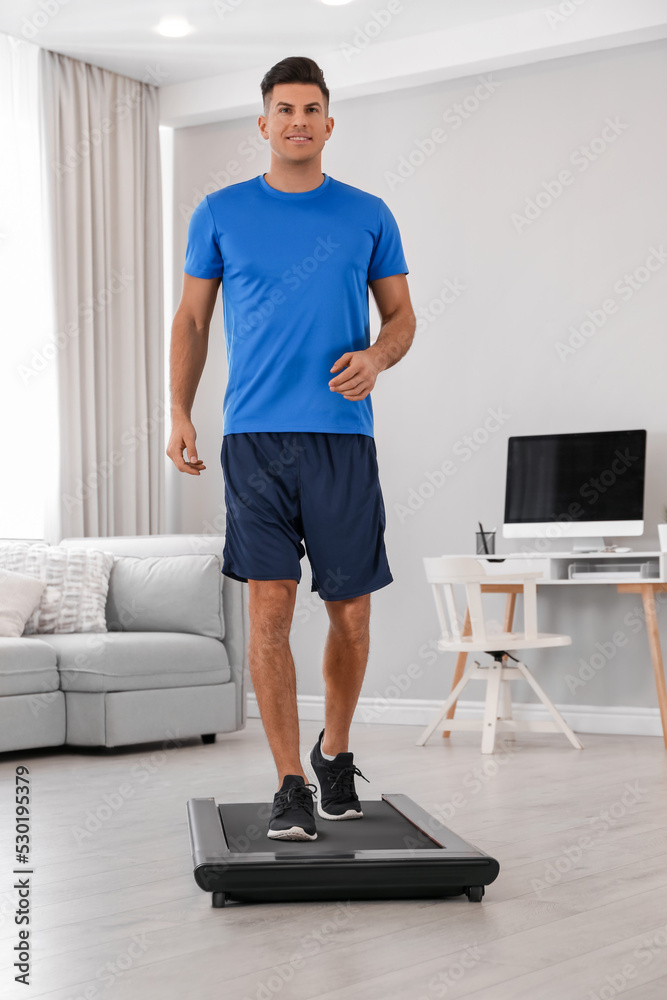 Sticker sporty man training on walking treadmill at home