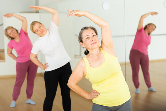 Mature women dancing aerobics at lesson in the dance class