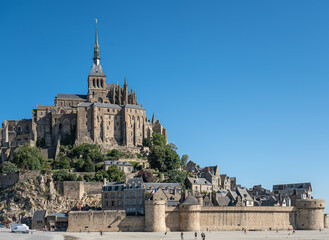 Mont St. Michel, Normandy, France - July 8, 2022: Brown stone ramparts and historic abbey structure...