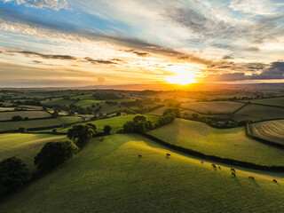 Sunset over Farmlands and Fields from a drone, Devon, England, Europe