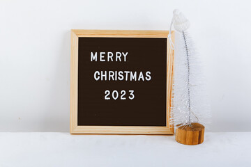 Merry Christmas lettering on letter board. Eco tree. minimalistic new year background 2023
