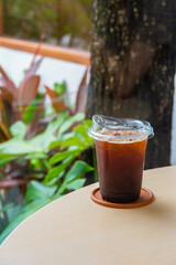 Iced Americano on a pastic glass in cafe, Black coffee, Advertising design americano coffee in cafe.