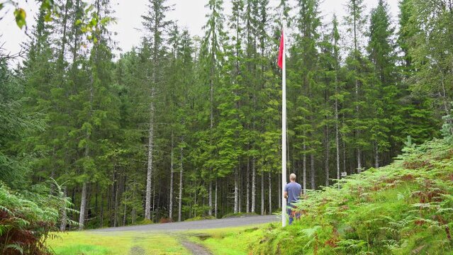 Man Hoisting Red Flag To Warn People That Shooting Is About To Start At Shooting Range -  Caution Symbol