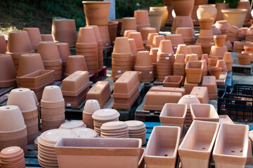 Clay pots of various shapes and sizes for flowers and garden plants for sale on open market