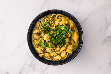 healthy plant-based food, vegan shell pasta with chickpeas and spinach in creamy sauce