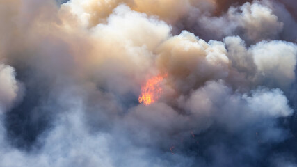 BC Forest Fire and Smoke over the mountain near Hope during a hot sunny summer day. British Columbia, Canada. Wildfire natural disaster